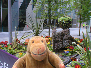 Mr Monkey looking at the bookworm outside the Library