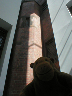 Mr Monkey looking at the old wall surrounded by new walls