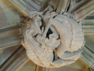 Two dragons on a boss on the vaulting of the cloister