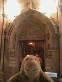 Mr Monkey in front of one of the doors to the Rylands Gallery
