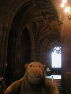 Mr Monkey looking up at the medieval walls of York