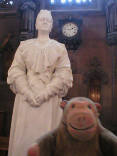 Mr Monkey looking at the statue of Enriqueta Rylands