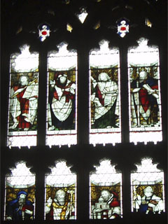 Religious figures in the stained glass of the west window