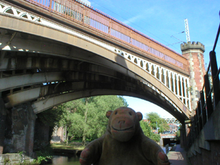Mr Monkey looking at the Manchester South Junction and Altrincham Railway bridge over the Rochdale Canal