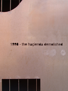 '1998 - the Haçienda demolished' cut into a metal panel