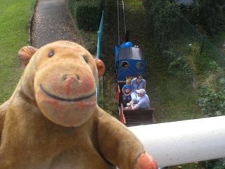 Mr Monkey watching a Miniature Railway train pass under the pier