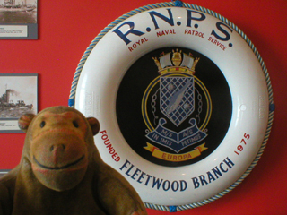 Mr Monkey looking at the symbol of the Fleetwood branch of the Royal Naval Patrol Service
