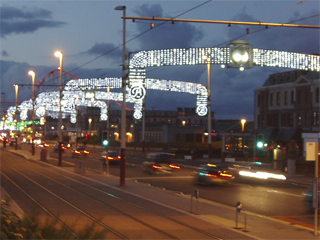 Cars passing through illuminated arches