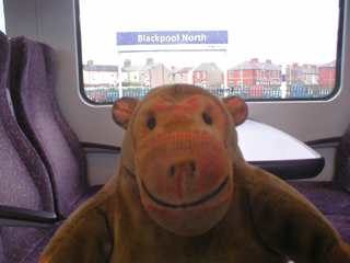 Mr Monkey looking at Blackpool from his train