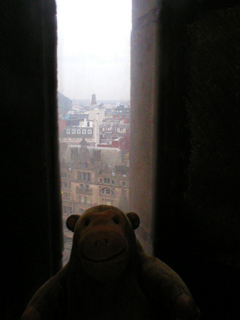 Mr Monkey looking out of a window in the tower's sprial staircase