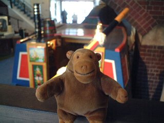 Mr Monkey looking down on a brightly painted narrowboat