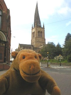 Mr Monkey in front Chesterfield's crooked spire