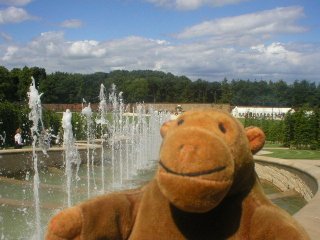 Mr Monkey in front of water spouts on the cascade