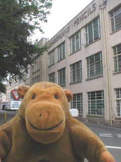 Mr Monkey outside a pencil factory
