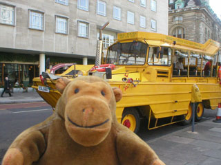 Mr Monkey in front of a yellow DUKW