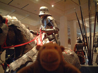 Mr Monkey in front of a suit of Gothic armour