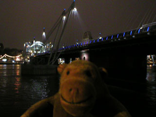 Mr Monkey beside Hungerford foot bridge by night