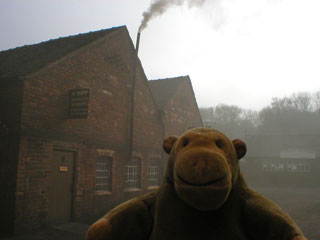 Mr Monkey outsie a very smoky tinsmiths shop