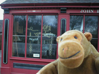 Mr Monkey outside the printer's shop