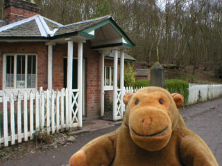 Mr Monkey outside a tollhouse