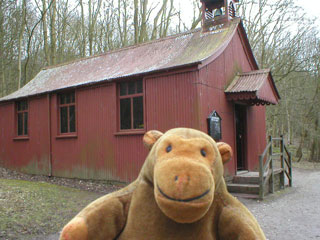 Mr Monkey outside a corrugated iron church