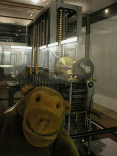 Mr Monkey with a replica of Babbages Difference Engine