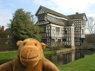 Mr Monkey looking across the moat to the Hall