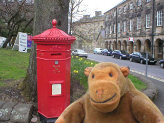 Mr Monkey beside a Victorian pillar box