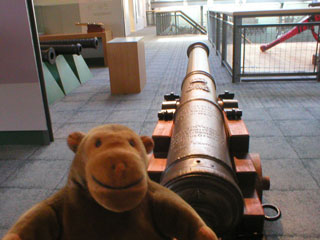 Mr Monkey with a cannon on a ship's carriage