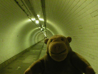 Mr Monkey walking through the Woolwich Foot tunnel