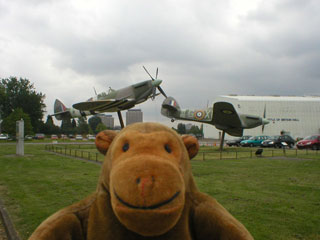 Mr Monkey in front of Spitfire and Hurrican replicas
