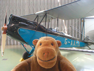 Mr Monkey in front of a Gypsy Moth biplane