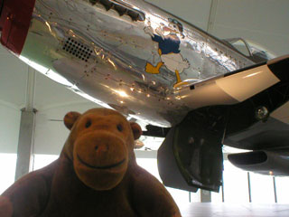 Mr Monkey under the nose of a Mustang fighter
