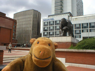 Mr Monkey with the statue of Newton behind him