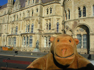 Mr Monkey passing the old university buildings
