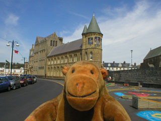 Mr Monkey with the old university and the crazy golf course behind him