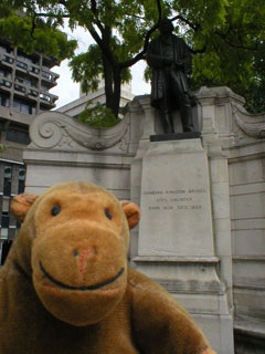 Mr Monkey in front of a statue of Isembard Kingdom Brunel
