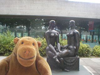 Mr Monkey in front of the London Pride sculpture