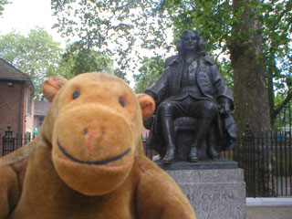 Mr Monkey with a statue of Captain Thomas Coram