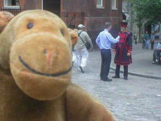 Mr Monkey with a Yeoman Warder behind him