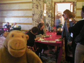 Mr Monkey watching authors sign books