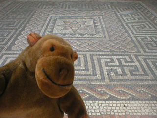 Mr Monkey looking at a mosiac floor