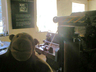 Mr Monkey with a carding machine