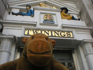 Mr Monkey looking at the decoration over the door of Twinings tea and coffee shop
