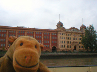 Mr Monkey passing Harrods Furniture Depository