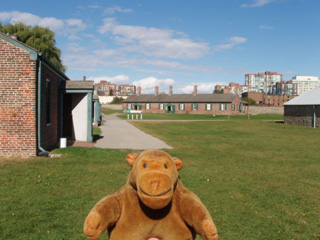 Mr Monkey beside the brick barracks
