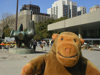 Mr Monkey approaching a Henry Moore sculpture