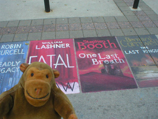 Mr Monkey looking at chalk pictures of book covers