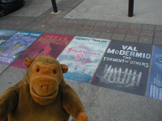 Mr Monkey looking at chalk pictures of book covers