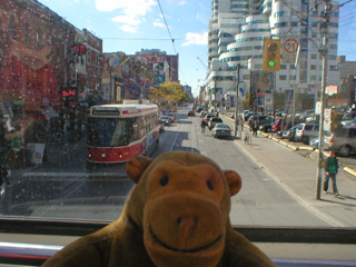 Mr Monkey at the front of the bus going down Queens Street